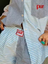 Shorts patchwork con estampado a rayas en tonos pastel (lila, amarillo, celeste y blanco) y detalle de bordado con la palabra 'pur' en verde.