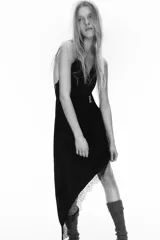 Vestido midi de satén negro con escote en pico y tirantes finos ajustables. Presenta un diseño asimétrico en el bajo con detalle de encaje a tono.