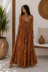 Vestido largo sin mangas color naranja con estampado paisley, escote en V y tirantes finos regulables con borlas colgantes.