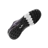Championes de fútbol Joma Maxima, diseñados para césped artificial. Presentan un diseño de perfil bajo con cordones, fabricados en material sintético de alta calidad con detalles en color violeta y blanco sobre base negra. Cuentan con suela de goma con patrón de agarre optimizado y sistema de ventilación.