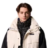 Campera técnica Columbia de la colección Iconos, con diseño impermeable y transpirable Omni-Tech. Presenta un estilo retro con bloques de color en crema y negro, cuello alto con forro interior azul, cierre frontal con solapa protectora y múltiples bolsillos. Incluye sistema de intercambio con cremallera para usar con forro reversible.