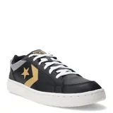Championes urbanos Converse Pro Blaze V2 Luxe Sport, color negro con detalles en dorado y gris, con cordones blancos y suela blanca.