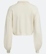 Cárdigan color crema de punto con cuello camisero, manga larga abullonada, cierre frontal abotonado y bolsillo de parche en el pecho.