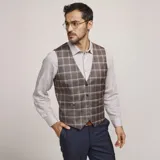 Chaleco reversible Due Volti de corte sastrero, con diseño a cuadros en tonos de gris y cierre frontal con cuatro botones oscuros.