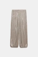 Pantalón bombacho de tiro medio con efecto metalizado, cintura elástica y bajo acabado en puño elástico.