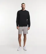 Buzo deportivo color verde claro, de manga larga y cuello redondo. Confeccionado en tejido de poliéster, viscosa y elastano.