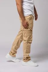 Pantalón cargo gris de gabardina con bolsillos laterales con fuelle y solapa, corte recto y tiro medio.