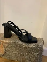 Sandalias negras de eco cuero con tiras finas, base cuadrada y taco bloque de 9 cm.