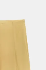 Falda midi de tiro medio con caída fluida y forro interior a tono. Presenta un diseño liso con cierre lateral mediante cremallera oculta.