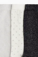 Pack de siete pares de medias de punto fino en mezcla de algodón. Incluye un par negro con brillo, un par negro liso, un par blanco con lunares, un par gris oscuro liso, un par gris claro liso, un par gris claro con brillo y un par blanco con lunares.