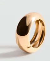 Pulsera rígida de metal dorado con diseño ancho, voluminoso y acabado brillante.
