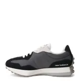 Championes urbanos New Balance modelo 327, con diseño retro que combina paneles de gamuza negra y malla gris. Presenta el logo 'N' sobredimensionado en color gris claro en el lateral, cordones blancos y una suela de goma con relieve que se extiende hacia el talón.