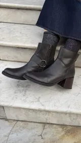 Botas cortas de cuero negro con punta fina y cierre lateral.