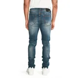 Pantalón de jean corte skinny color azul medio con efecto lavado, diseño de cinco bolsillos, cierre de cremallera y botón metálico con logo grabado.