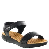 Sandalias Dijean modelo Tora, color negro, con tiras acolchadas y cierre de velcro ajustable en el tobillo. Presentan una plantilla texturizada en color tostado y suela de goma negra.