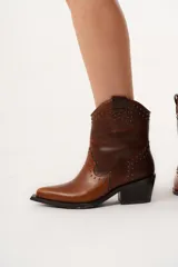 Bota texana de caña media-baja color marrón, con punta elegante y detalle de mini tachas.