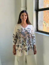 Sweater de punto con cuello en V, diseño holgado y estampado animal print con detalles en dorado.