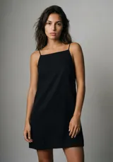 Vestido corto negro de corte recto, con escote cuadrado y tirantes finos.
