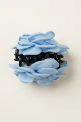 Broche en forma de rosa de tela color rojo, con diseño de pétalos superpuestos y sistema de sujeción tipo clip.