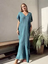 Vestido midi de tejido calado en color beige, con escote en V, mangas cortas y silueta holgada.