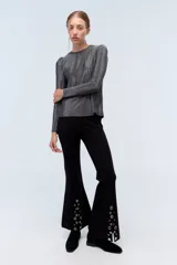 Remera plateada de lurex con escote redondo, calce al cuerpo y mangas largas estilo princesa.