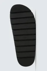 Zueco de piel con acabado serraje color beige, con plantilla anatómica, horma redonda y suela de volumen negra.