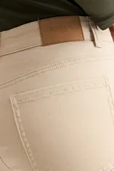 Pantalón de mujer color beige claro, tiro medio, corte recto y largo al tobillo.