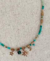 Collar de estilo boho con cuentas de piedra en tonos turquesa y verde, intercaladas con piezas metálicas doradas. Presenta dijes colgantes en forma de luna, estrella y una piedra rectangular.