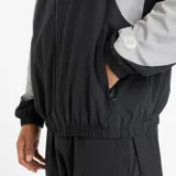 Campera deportiva New Balance negra con detalles en gris y blanco, cierre frontal y logo bordado en el pecho.