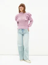 Buzo de tejido de punto calado en color lila, con cuello alto, mangas largas con puños ajustados y detalle de volados en los hombros.