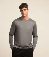 Remera deportiva de manga larga para hombre, color gris melange, con cuello redondo y tecnología dry con protección UV.