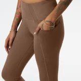 Calza deportiva color marrón de tiro alto, con bolsillos laterales y tecnología NB DRYx que absorbe la humedad.