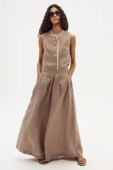 Pantalón palazzo color marrón claro, de tiro alto y confeccionado en lino.