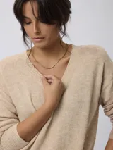 Sweater de punto con escote en V y manga larga, de calce relajado con puños y cintura tejidos.