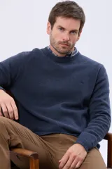Buzo de lana azul con cuello redondo, manga larga y diseño tejido de punto.