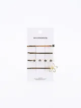 Set de cuatro hebillas para el pelo doradas con diferentes diseños: una con strass, una con perlas y una con forma de flor.