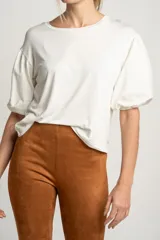 Remera blanca de manga corta abullonada con textura de puntos en relieve, escote redondo y calce holgado.