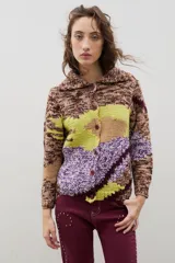 Saco de punto con diseño de bloques de color en técnica intarsia, combinando tonos marrones jaspeados, verde lima y violeta. Presenta cuello redondo, cierre frontal con botones y mangas largas.