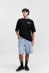 Bermuda de jean con calce baggy, corte amplio y relajado en piernas y cadera, tiro medio, con pasa cinto y cierre frontal.
