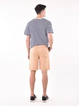 Bermuda de gabardina color beige, con cintura elástica y cordón ajustable, bolsillos laterales y corte recto.
