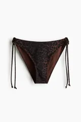 Vedetina de bikini con estampado animal print de leopardo, tiro estándar y tiras laterales para atar.