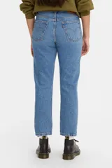 Jean de corte recto y estilo cropped, confeccionado en denim de algodón rígido. Presenta un lavado azul medio con efecto desgastado, tiro medio y cierre de botones clásico de la línea 501.