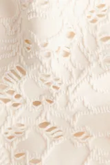Vedetina cheeky de baño color crudo, con textura de encaje floral y tiro bajo.