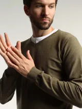 Sweater de punto con cuello en V, manga larga y puños acanalados, de corte clásico.