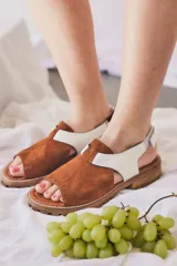 Sandalias marrones con textura tipo reptil, con tiras anchas y ajuste con velcro en el tobillo.