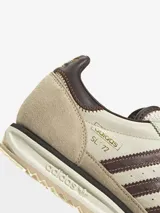Zapatillas Adidas modelo SL 72, con diseño retro en tonos crema y marrón. Presentan una base de cuero con superposiciones de gamuza, las icónicas tres tiras laterales en marrón y una mediasuela de EVA con suela de caucho dentada.