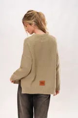 Sweater color arena de lana merino con cuello redondo y mangas largas.