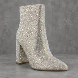 Botas de tacón alto con diseño enteramente cubierto de pedrería y brillos tornasolados, con punta fina y taco ancho.