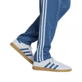 Pantalón deportivo Adidas de corte recto, color azul con las icónicas tres tiras blancas laterales y logo del trébol bordado en la pierna. Cuenta con cintura elástica y cierre en los tobillos.