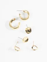 Set de tres pares de aros plateados con cierre de perno. Incluye un par de aros tipo argolla gruesa, un par con forma irregular y un par con diseño abstracto.